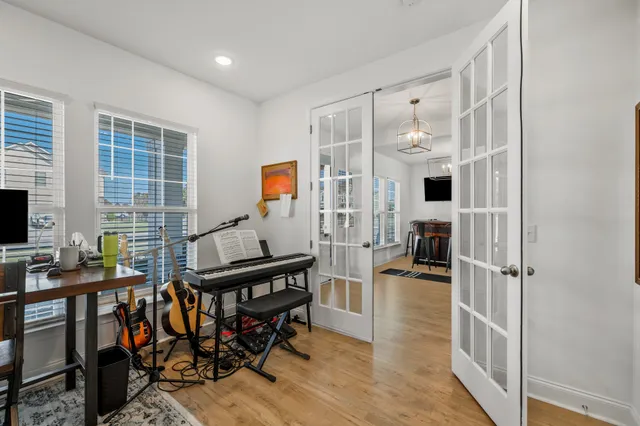 a kitchen with stainless steel appliances kitchen island granite countertop a table chairs and a refrigerator