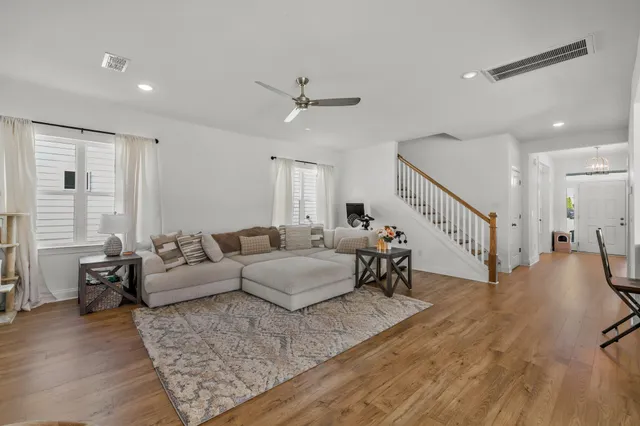 a living room with furniture and wooden floor