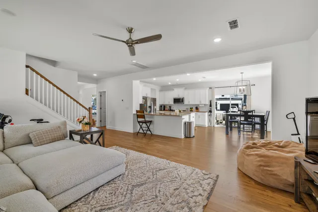a living room with furniture and a view of kitchen