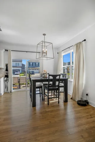 a view of a dining room with furniture and wooden floor