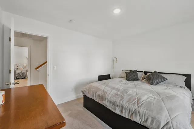 a bedroom with double bed and a rug