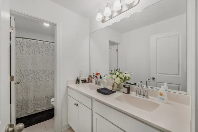 a bathroom with a sink double vanity and a mirror