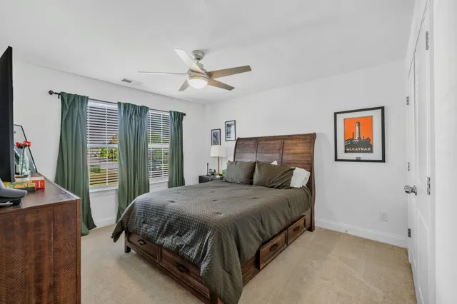 a bedroom with a large bed and a flat tv screen