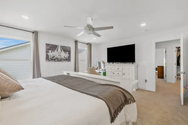 a bedroom with bed tv and flat screen tv