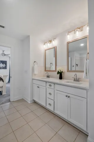 a spacious bathroom with a granite countertop sink mirror and