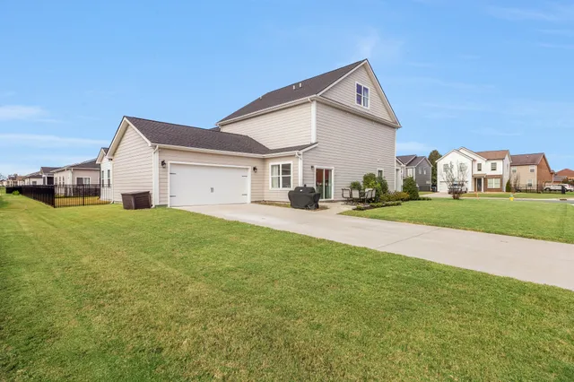 a front view of house with yard and green space