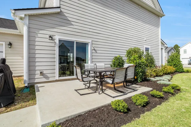 a view of a chairs and table in patio