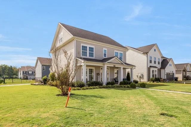 a front view of building with yard and green space