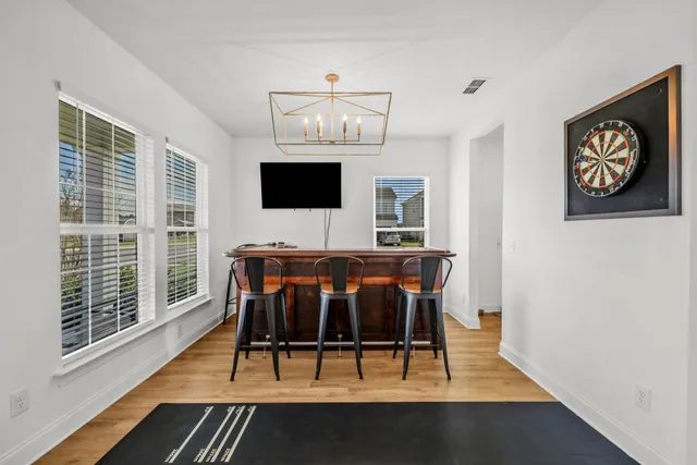 a living room with furniture a flat screen tv and a table
