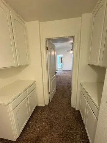 a view of an empty room with a fan