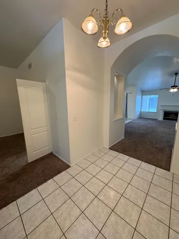 a view of empty room with a fireplace