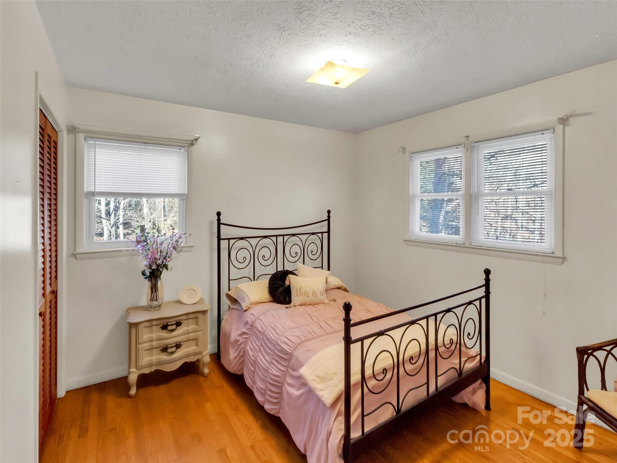 250 Reeves Cove Road Candler, NC 28715 - Photo 12 of 47 a bedroom with a bed and a window