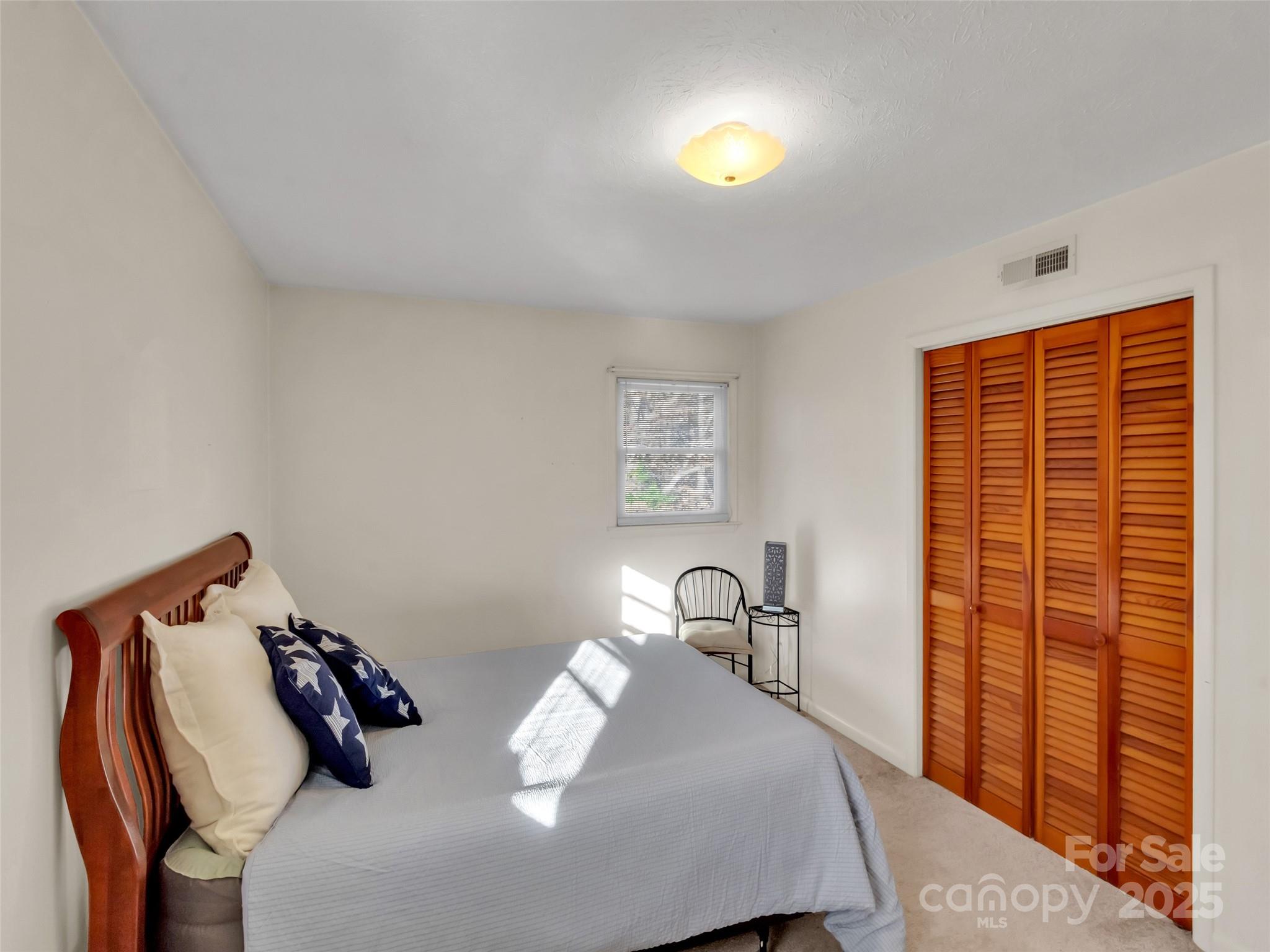 250 Reeves Cove Road Candler, NC 28715 - Photo 14 of 47 a bedroom with bed and a window