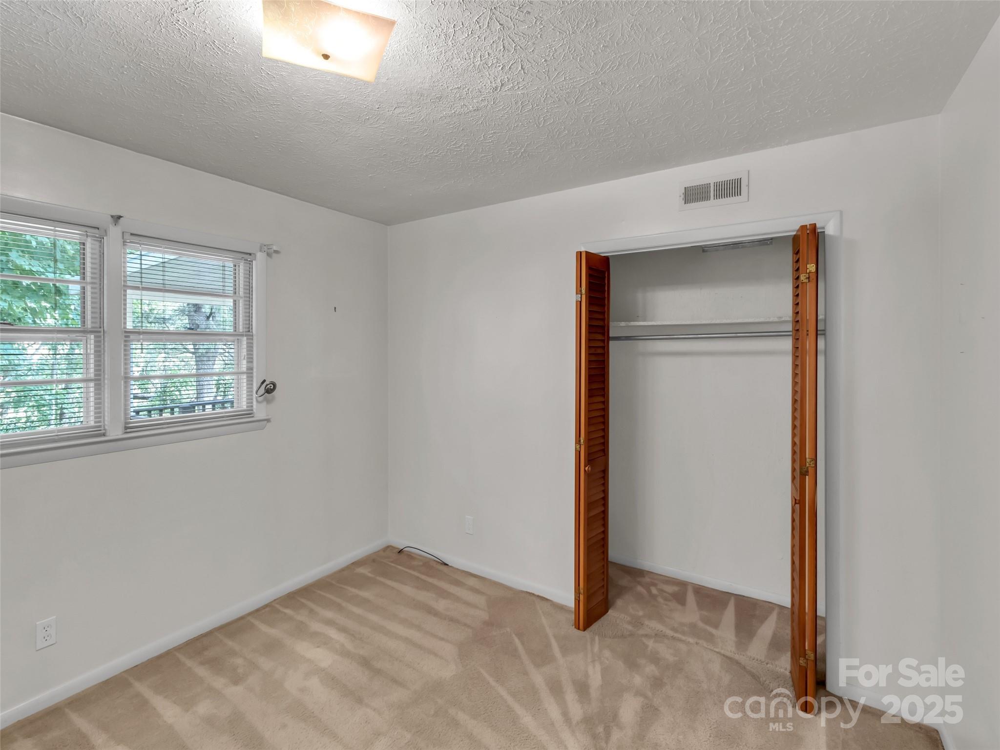 250 Reeves Cove Road Candler, NC 28715 - Photo 21 of 47 a view of an empty room with a window