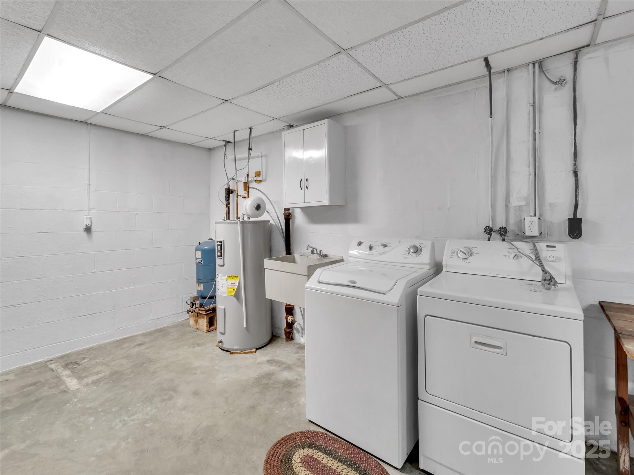 250 Reeves Cove Road Candler, NC 28715 - Photo 27 of 47 a view of storage and utility room with washer and dryer