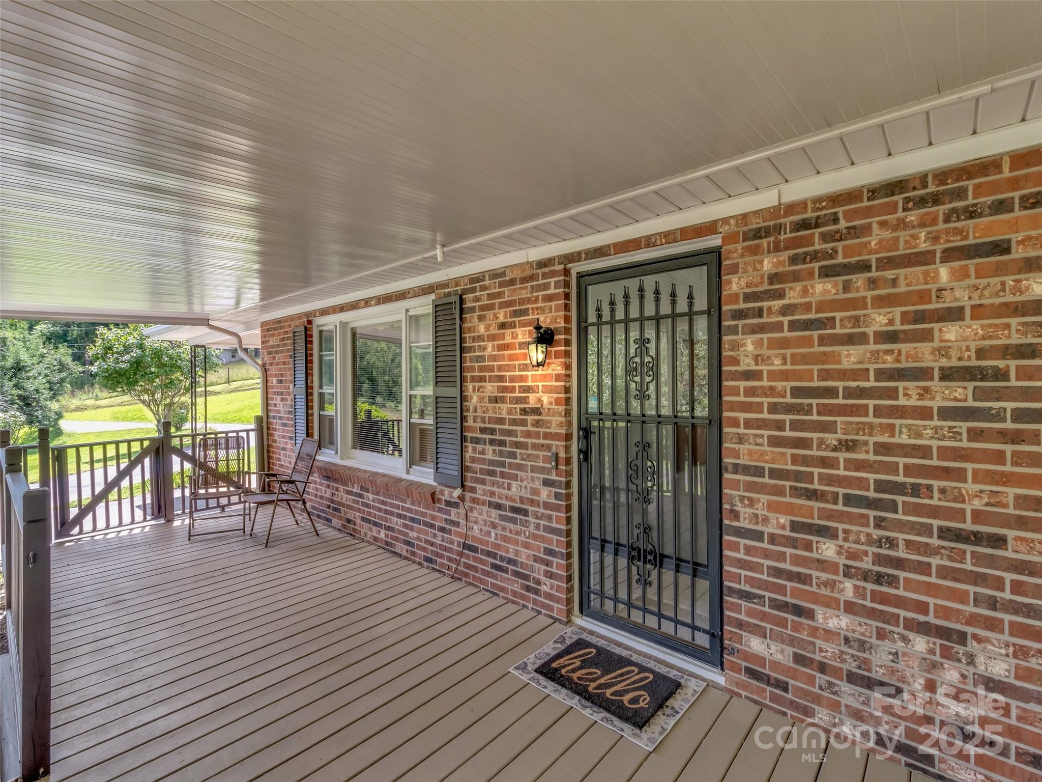 250 Reeves Cove Road Candler, NC 28715 - Photo 3 of 47 a view of a balcony with wooden floor
