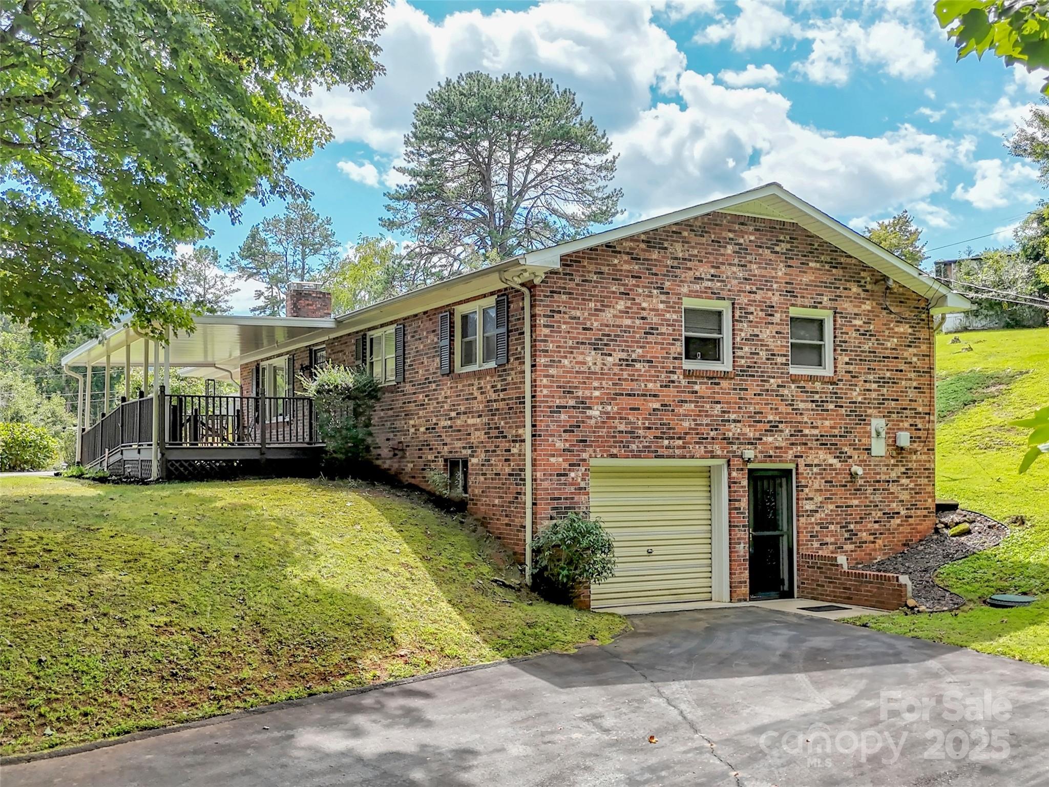 250 Reeves Cove Road Candler, NC 28715 - Photo 35 of 47 a front view of a house with a yard and garage