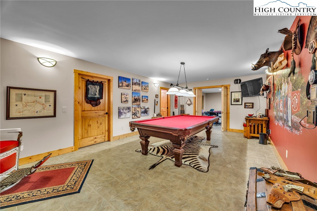 2650 Carson Woods Road Laurel Springs, NC 28644 - Photo 31 of 50 a room with furniture pool table and paintings on the wall