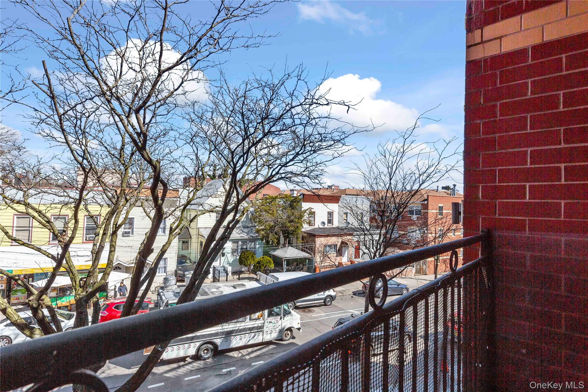 10716 37th Avenue, Unit 3B Queens, NY 11368 - Photo 13 of 19 a view of a balcony with a street