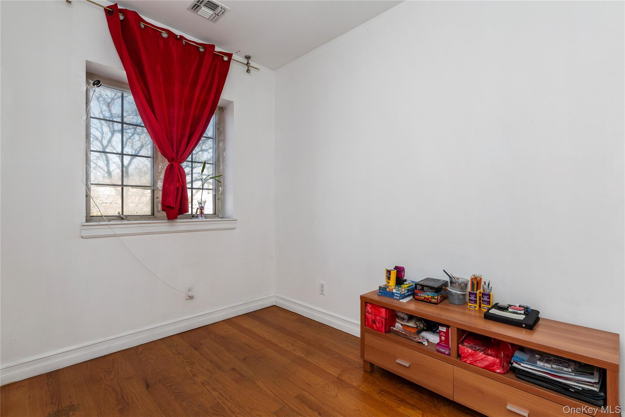 10716 37th Avenue, Unit 3B Queens, NY 11368 - Photo 15 of 19 a room with toys and a wooden floor