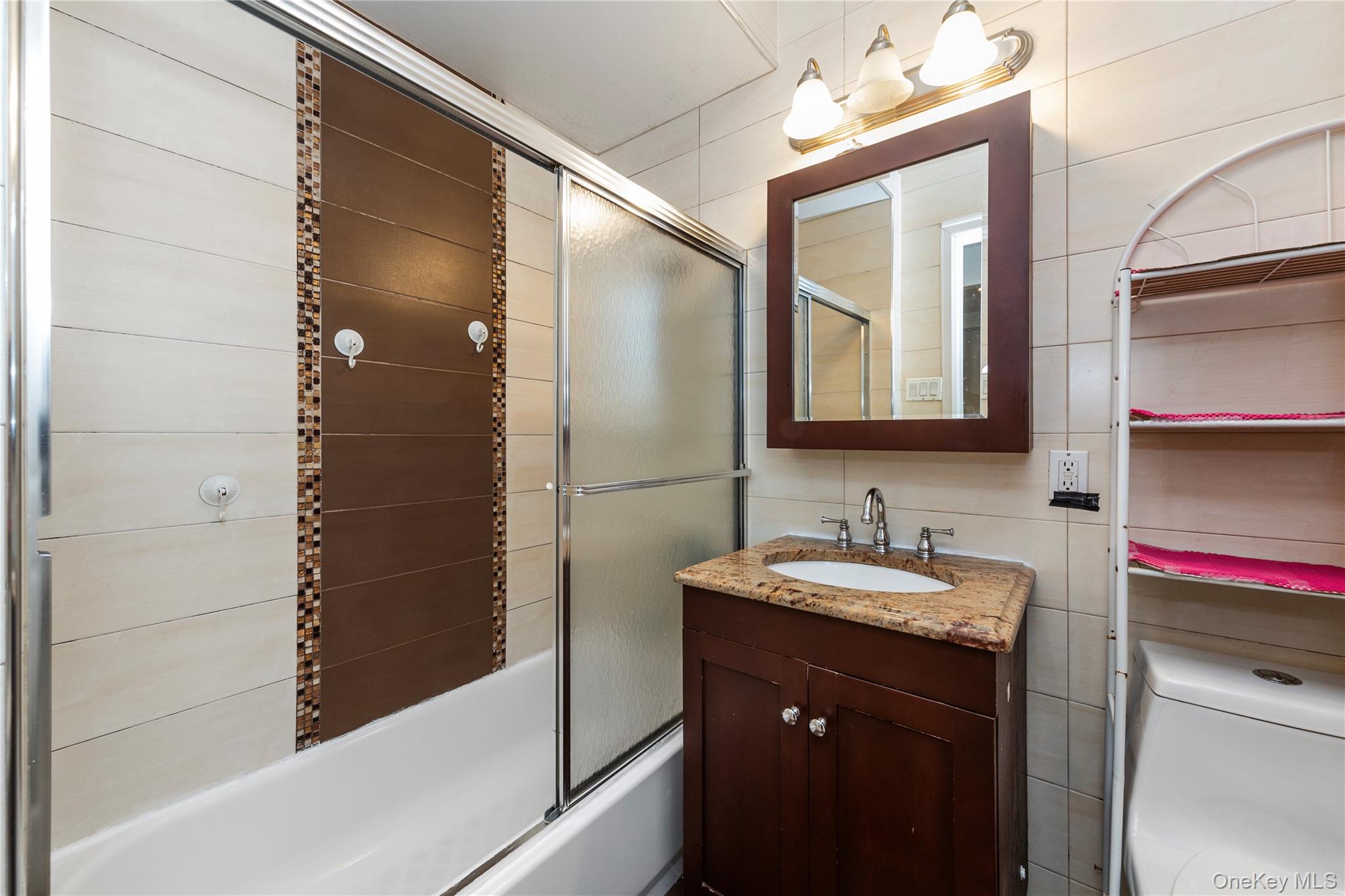 10716 37th Avenue, Unit 3B Queens, NY 11368 - Photo 9 of 19 a bathroom with a sink and a mirror
