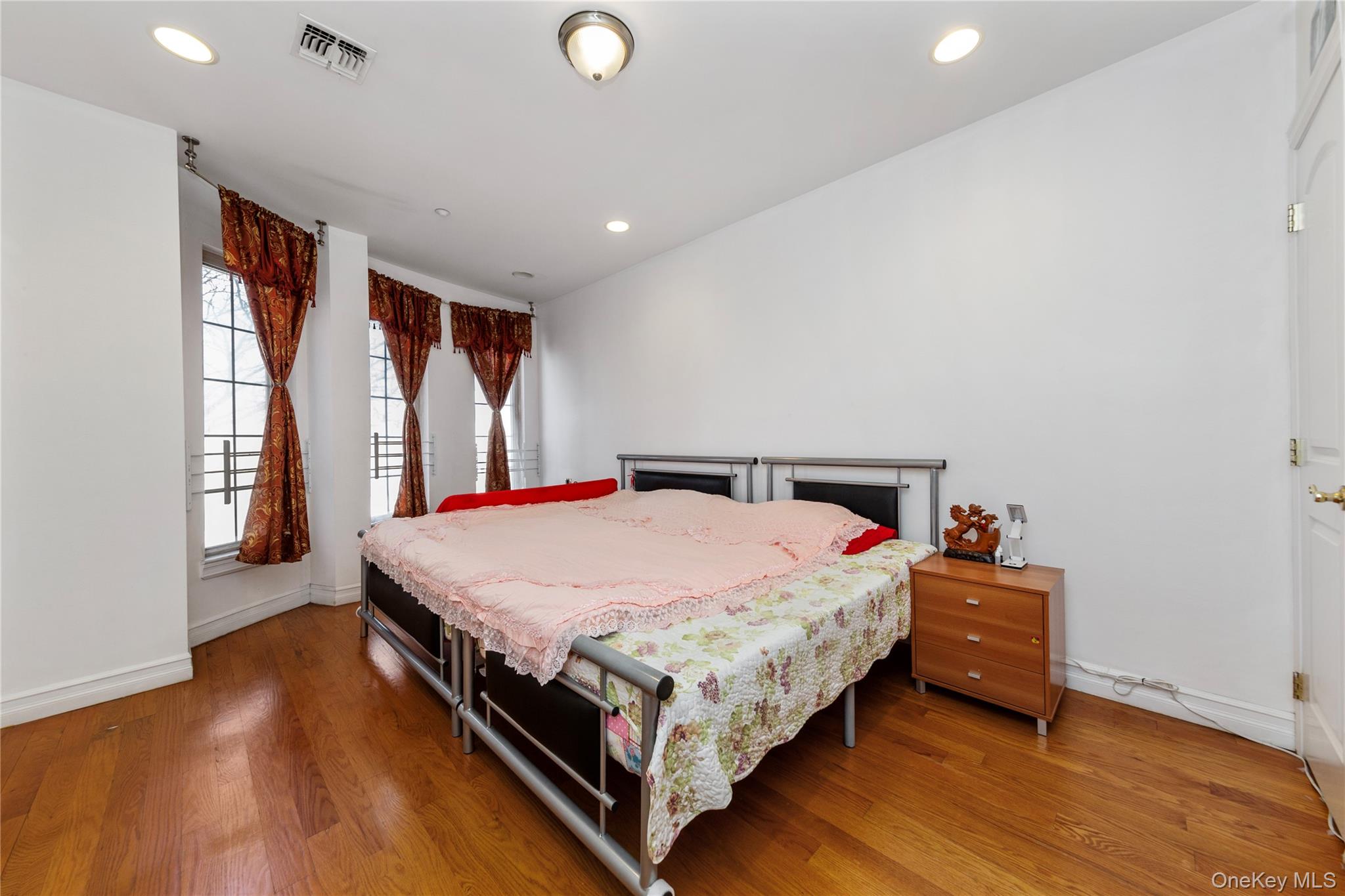 10716 37th Avenue, Unit 3B Queens, NY 11368 - Photo 10 of 19 a bed room with a bed and a large window