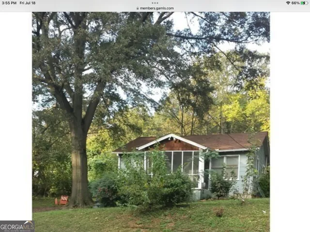 a front view of a house with yard and green space