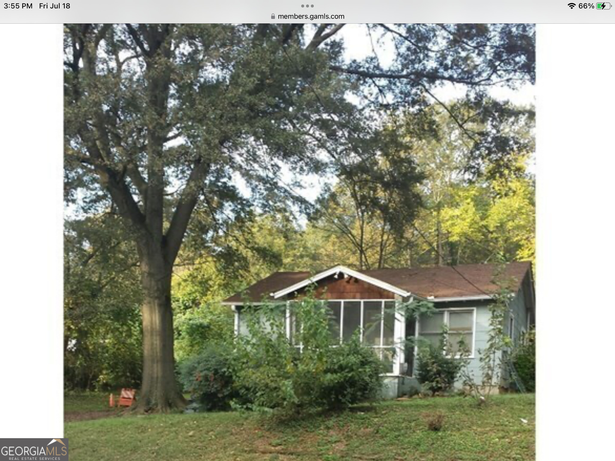 a front view of a house with yard and green space