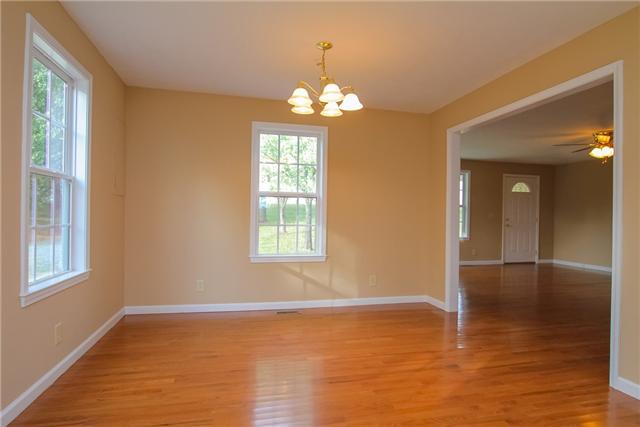 5031 Brick School Road Springfield, TN 37172 - Photo 8 of 12 a view of an empty room with window and wooden floor