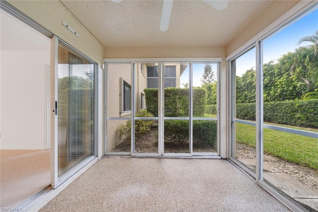 7761 Jewel Lane, Unit 103 Naples, FL 34109 - Photo 19 of 26 a big room with yard and balcony view