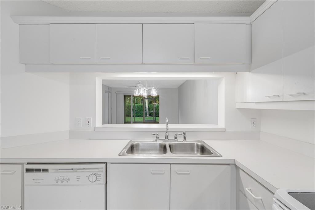 7761 Jewel Lane, Unit 103 Naples, FL 34109 - Photo 2 of 26 a view with a sink and cabinets