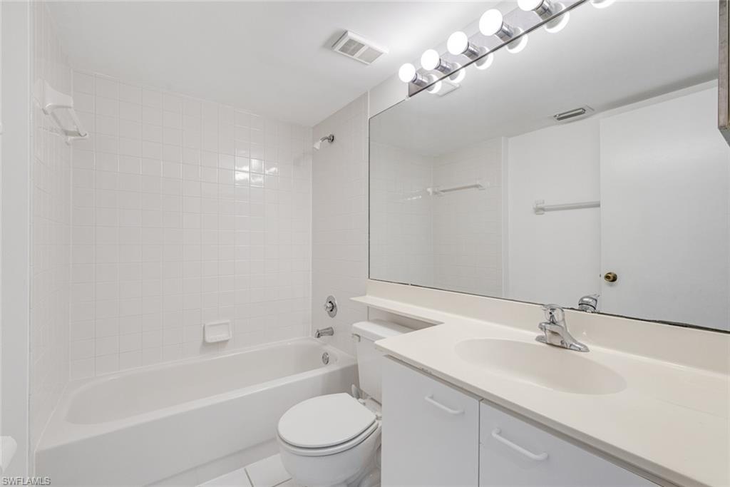 7761 Jewel Lane, Unit 103 Naples, FL 34109 - Photo 7 of 26 a bathroom with a sink a toilet and shower