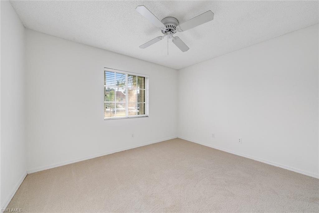7761 Jewel Lane, Unit 103 Naples, FL 34109 - Photo 9 of 26 an empty room with a window