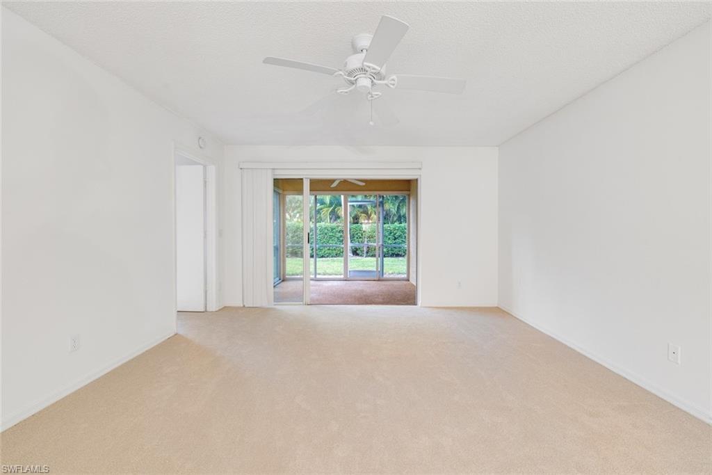 7761 Jewel Lane, Unit 103 Naples, FL 34109 - Photo 10 of 26 an empty room with a window and a ceiling fan