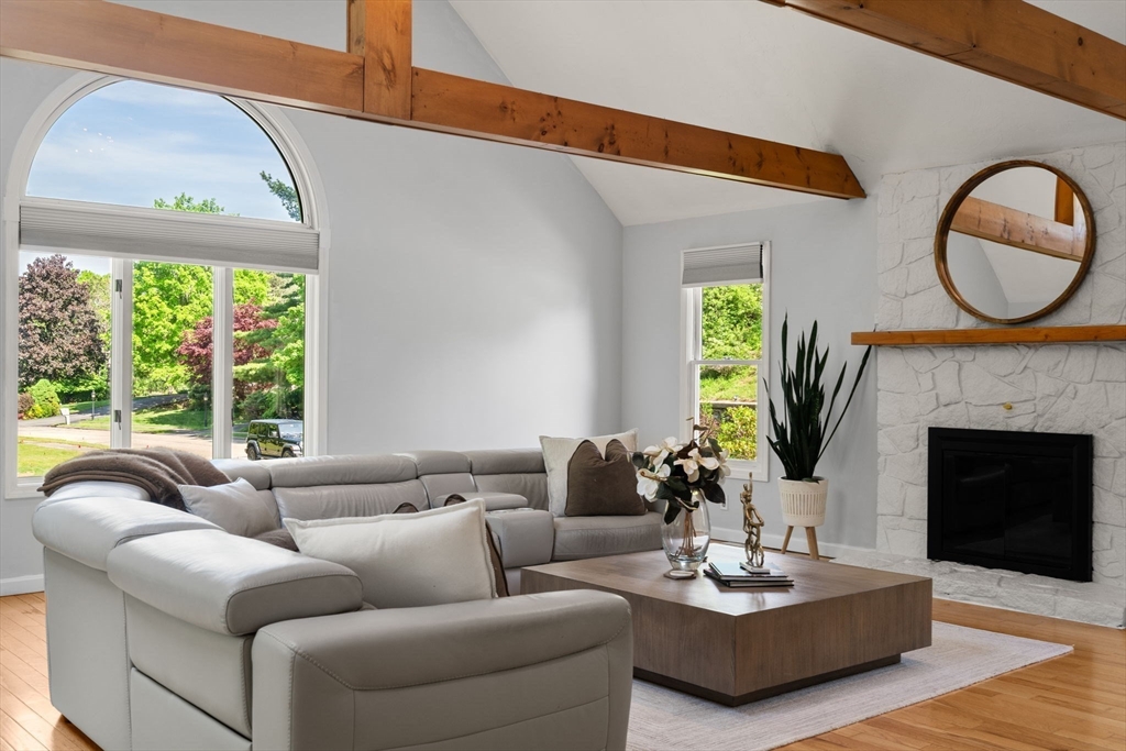 11 Cow Hill Road Sharon, MA 02067 - Photo 15 of 30 a living room with furniture a fireplace a potted plant and a large window