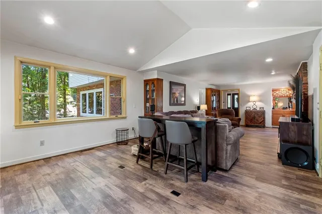 a living room with furniture a window and a table