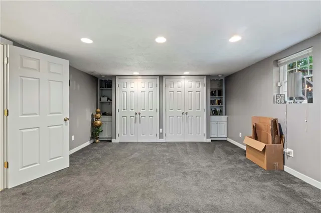an empty room with furniture and a large window