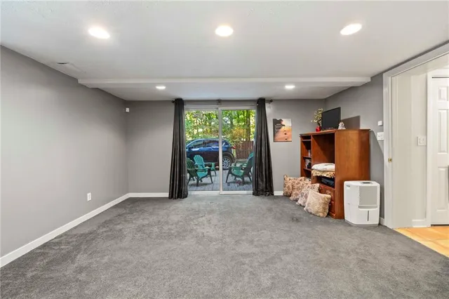 a bedroom with a bed and a dresser with wooden floor
