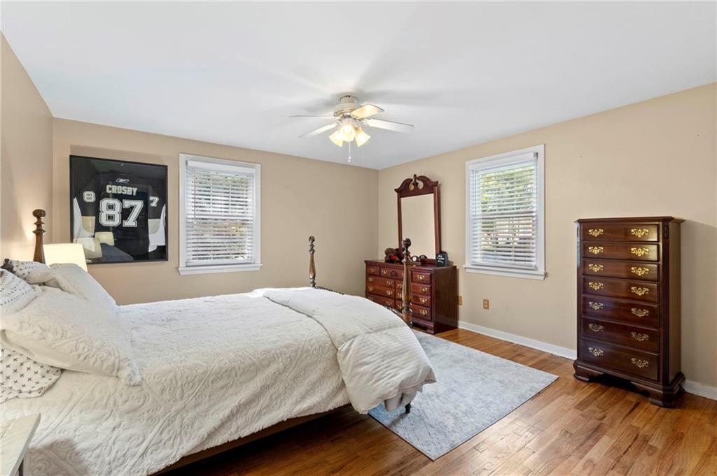 21 Oakglen Drive Oakmont, PA 15139 - Photo 22 of 50 a bedroom with a bed and a dresser with wooden floor