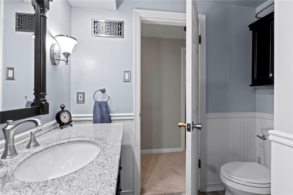 21 Oakglen Drive Oakmont, PA 15139 - Photo 28 of 50 a bathroom with a granite countertop sink a mirror and a toilet