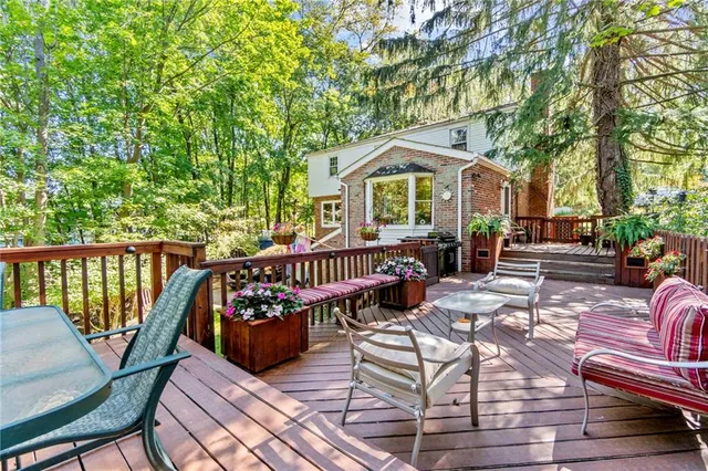 a view of a backyard with table and chairs and wooden fence
