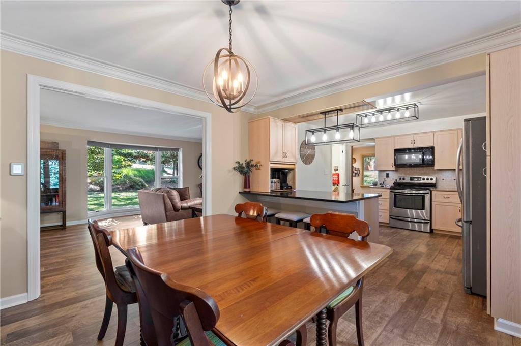 21 Oakglen Drive Oakmont, PA 15139 - Photo 8 of 50 a dining room with wooden floor a chandelier a wooden table and chairs