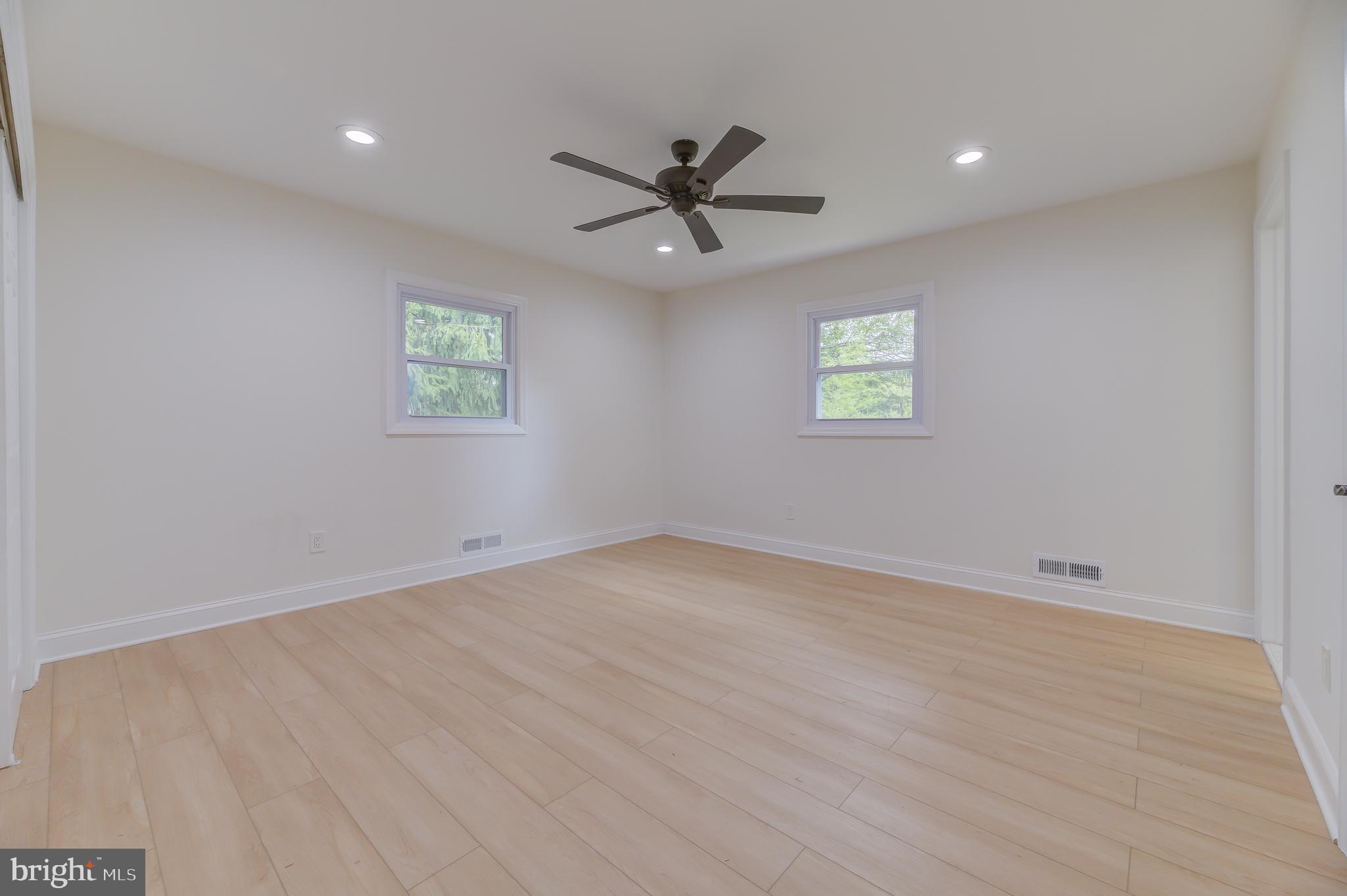 90 Princeton Hightstown Road Princeton Junction, NJ 08550 - Photo 15 of 20 an empty room with windows and fan