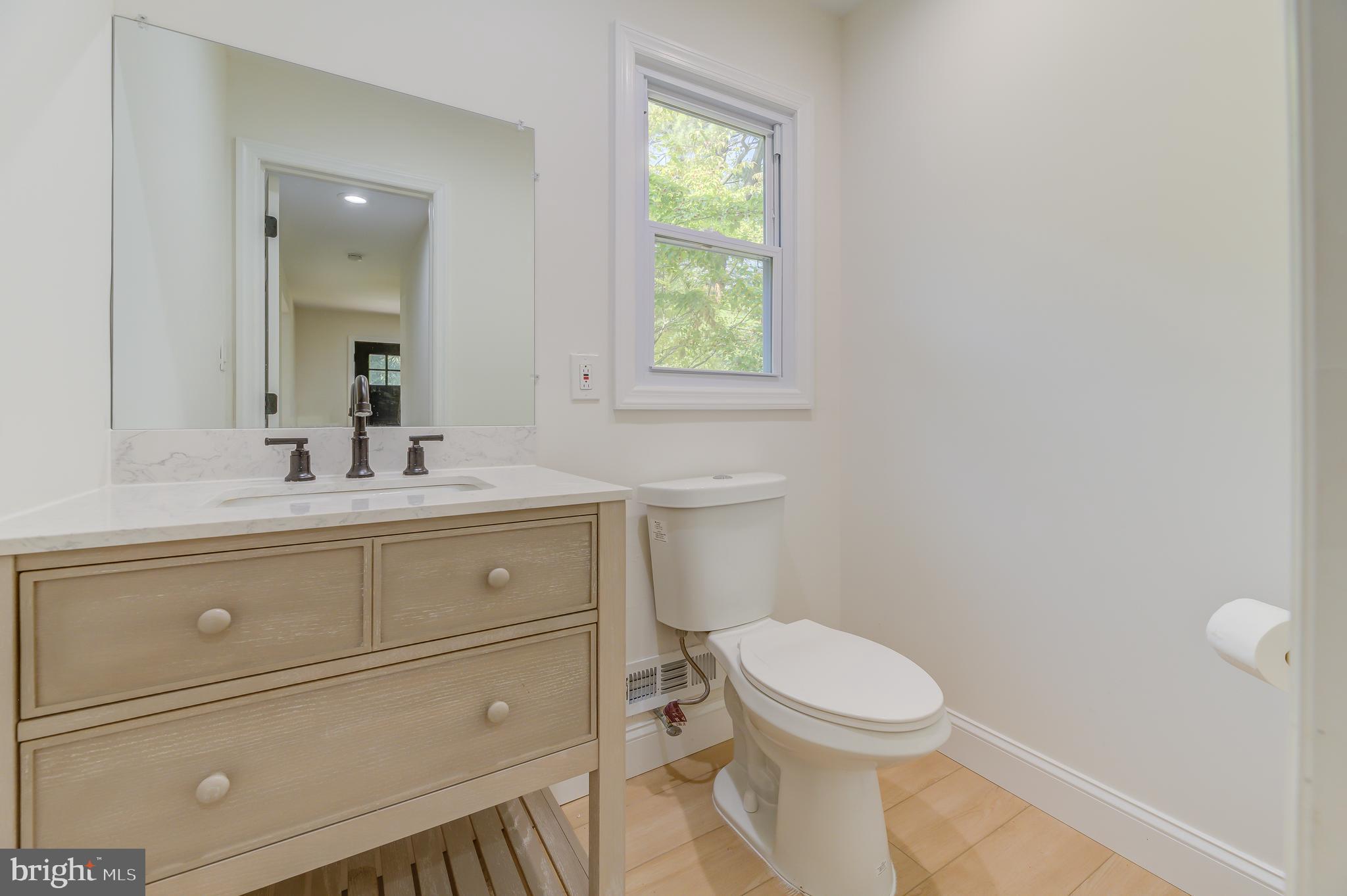 90 Princeton Hightstown Road Princeton Junction, NJ 08550 - Photo 16 of 20 a bathroom with a toilet a sink a vanity and mirror