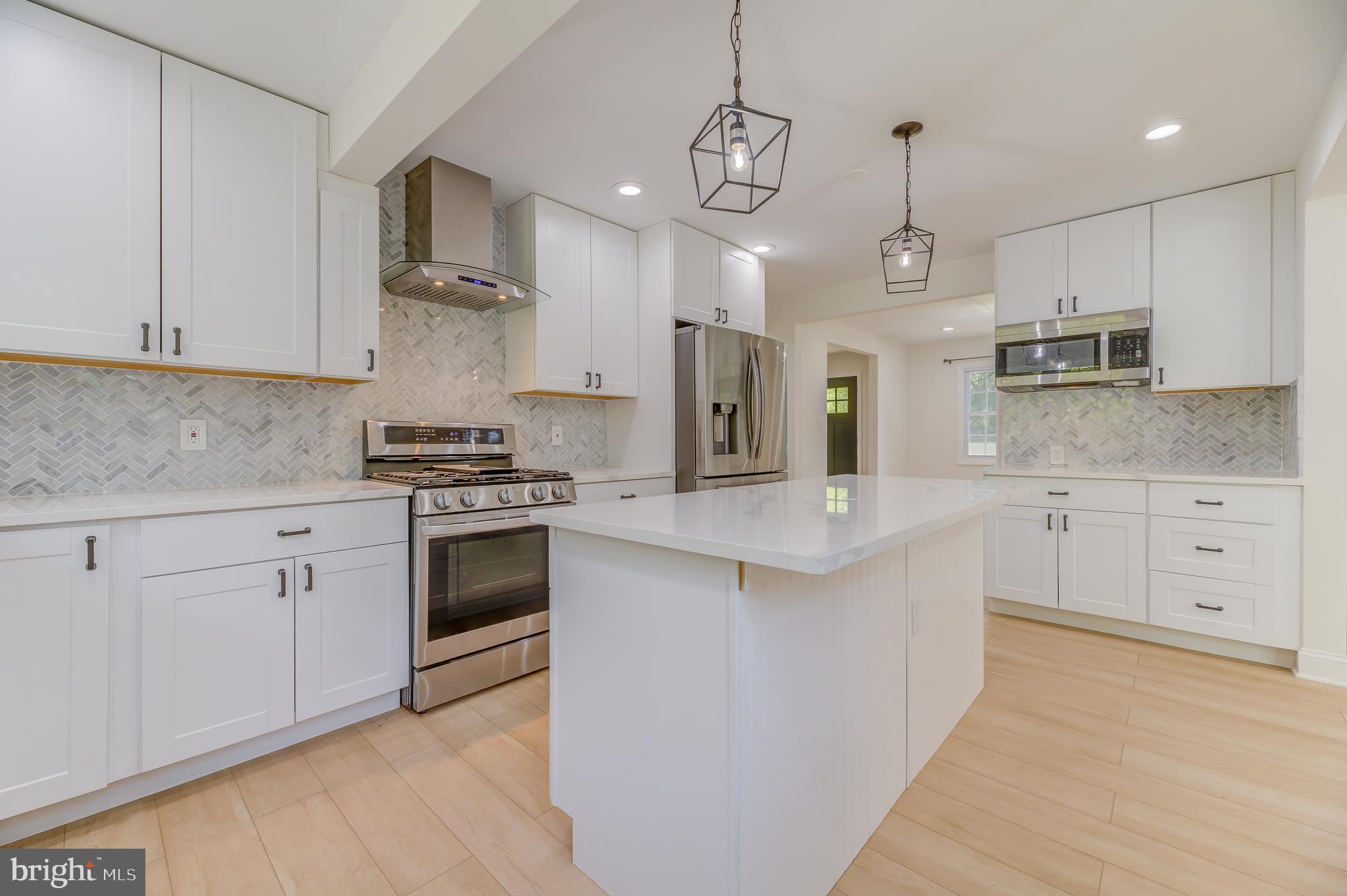 90 Princeton Hightstown Road Princeton Junction, NJ 08550 - Photo 6 of 20 a kitchen with kitchen island granite countertop stainless steel appliances cabinets a sink and a counter top space