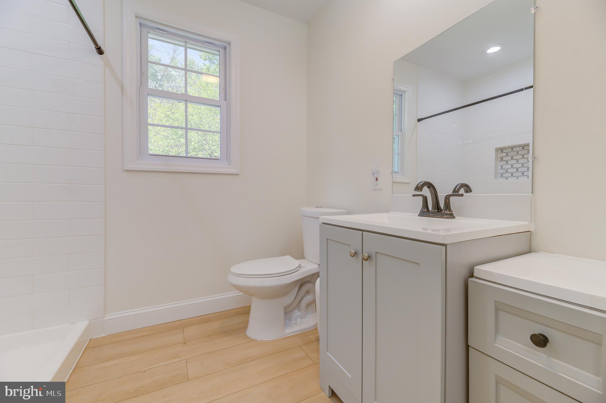 90 Princeton Hightstown Road Princeton Junction, NJ 08550 - Photo 10 of 20 a bathroom with a sink toilet and vanity