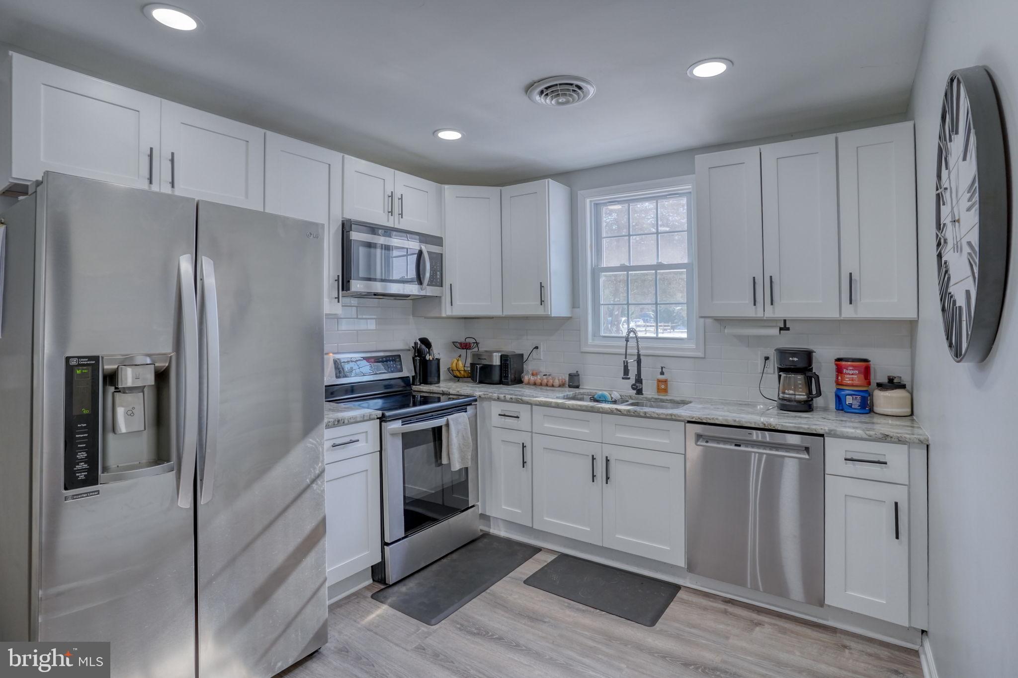 2613 Old County Road Newark, DE 19702 - Photo 29 of 50 Modern kitchen with sleek white cabinetry.