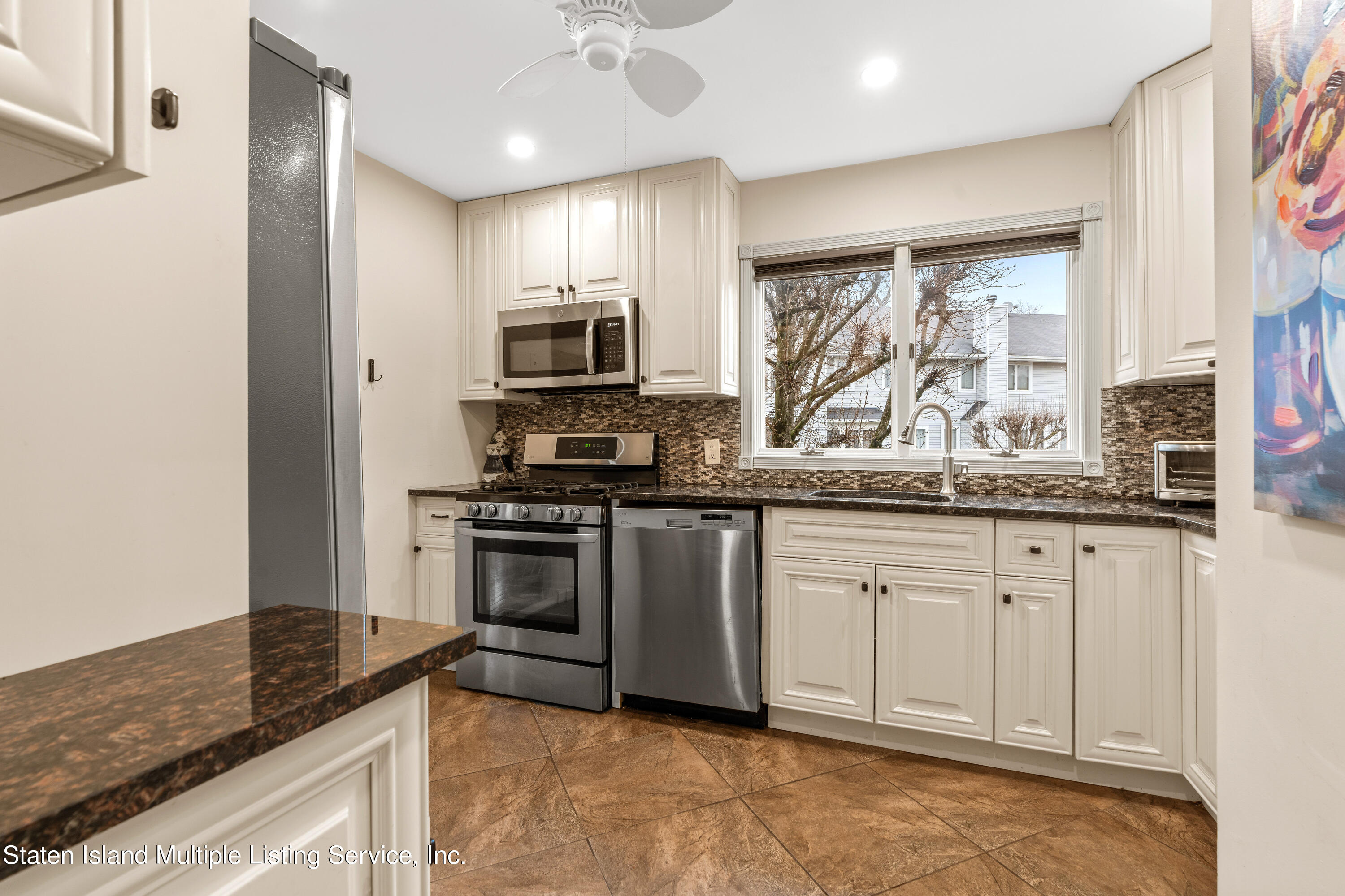 15 Flagship Circle Staten Island, NY 10309 - Photo 13 of 31 a kitchen with stainless steel appliances granite countertop a stove a sink and a microwave