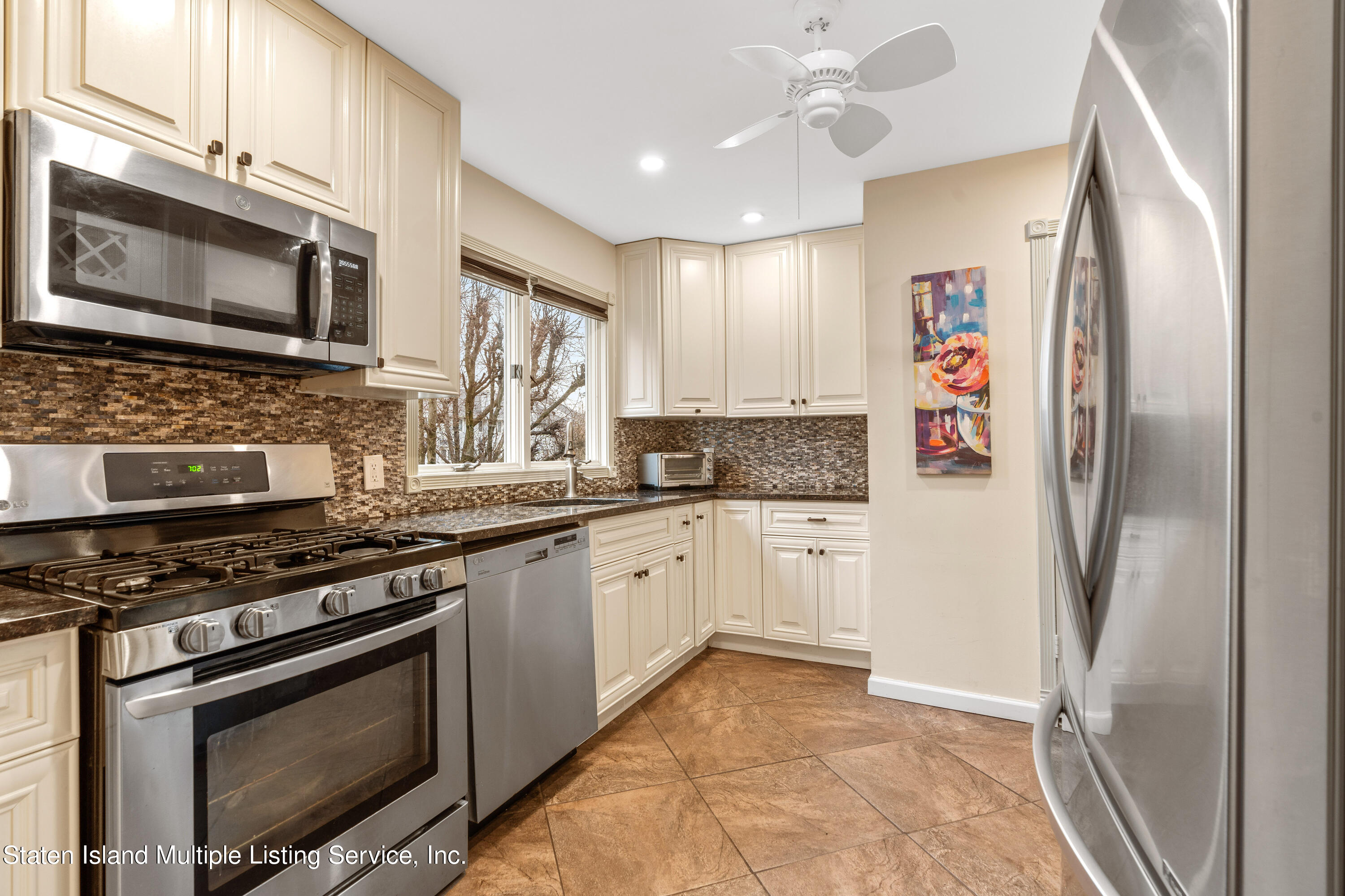 15 Flagship Circle Staten Island, NY 10309 - Photo 14 of 31 a kitchen with stainless steel appliances granite countertop a stove a refrigerator and a microwave