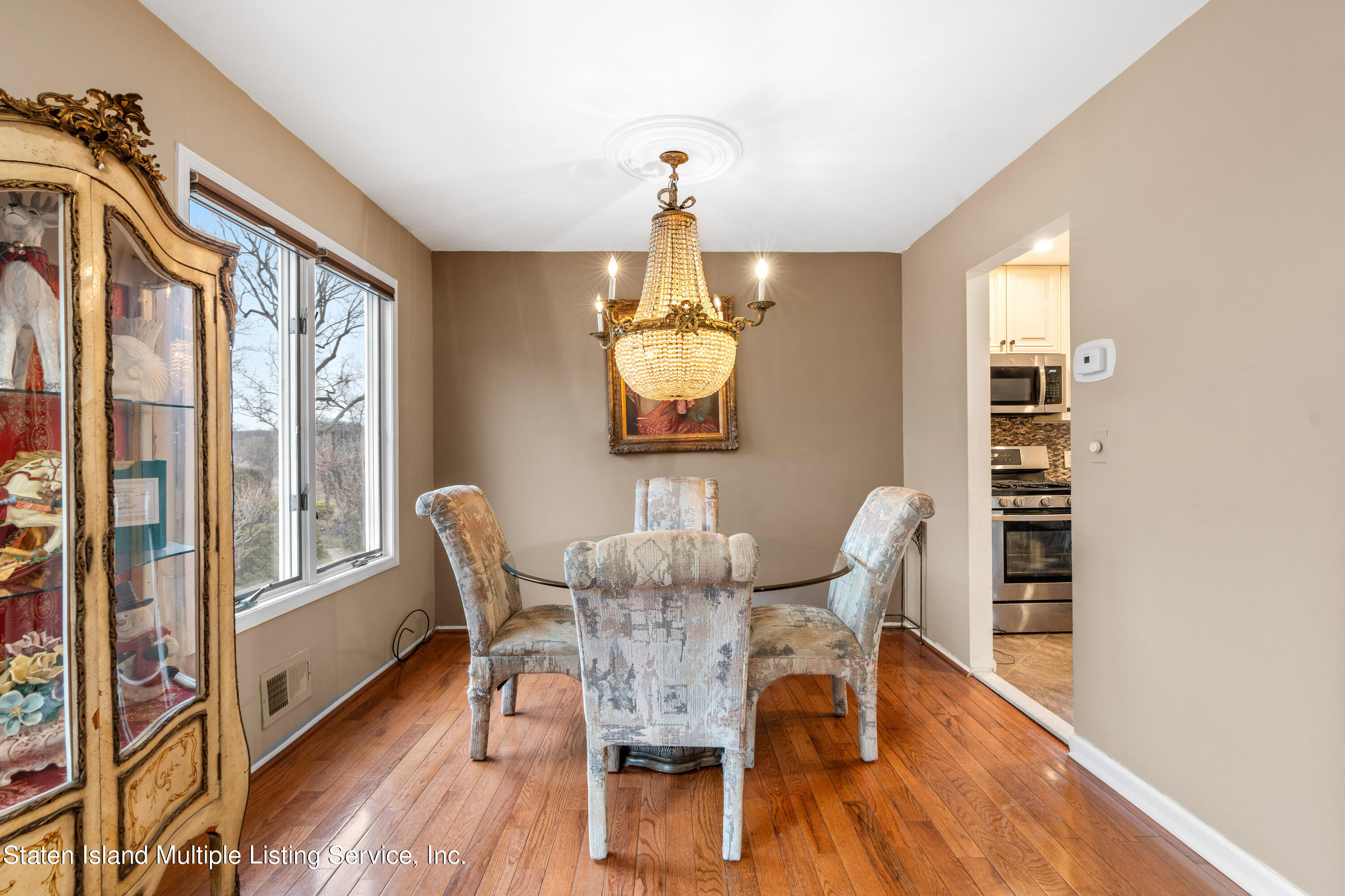 15 Flagship Circle Staten Island, NY 10309 - Photo 18 of 31 a dining room with furniture a chandelier and wooden floor